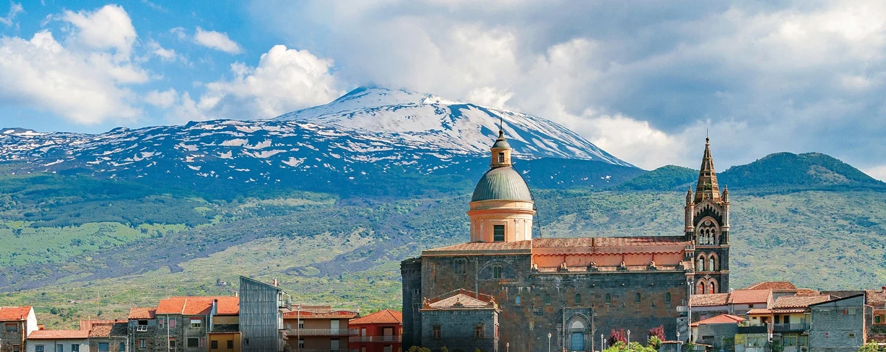 The church in Randazzo, Sicily, beneath snow-covered Mount Etna.